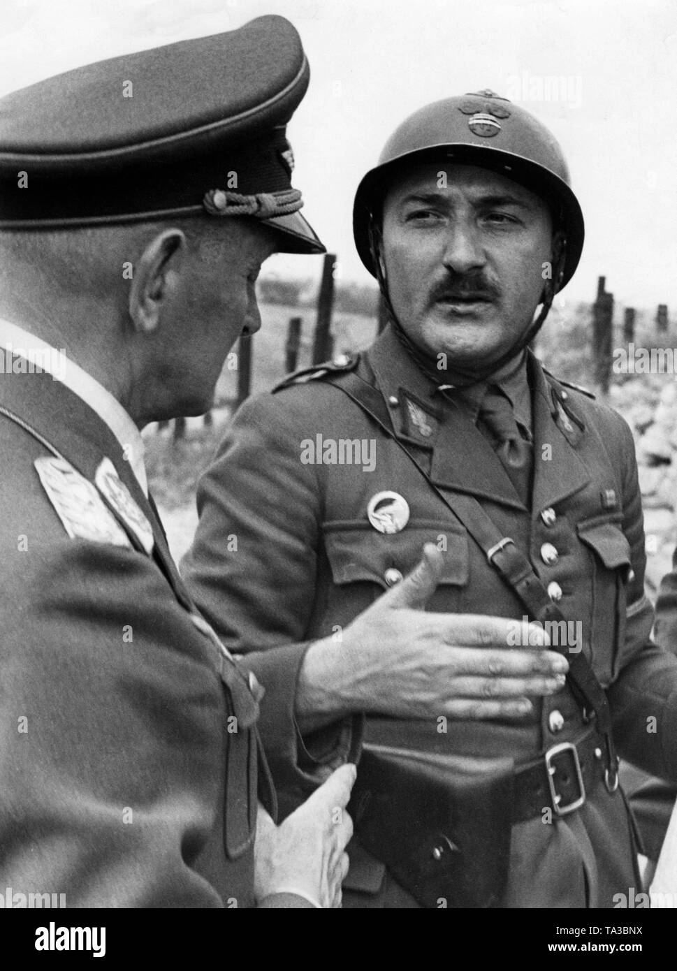 The French Captain Emy (right) describes to the German Luftwaffe General Zander the bombardment by Stukas after an attack on a plant of the Maginot Line. Stock Photo