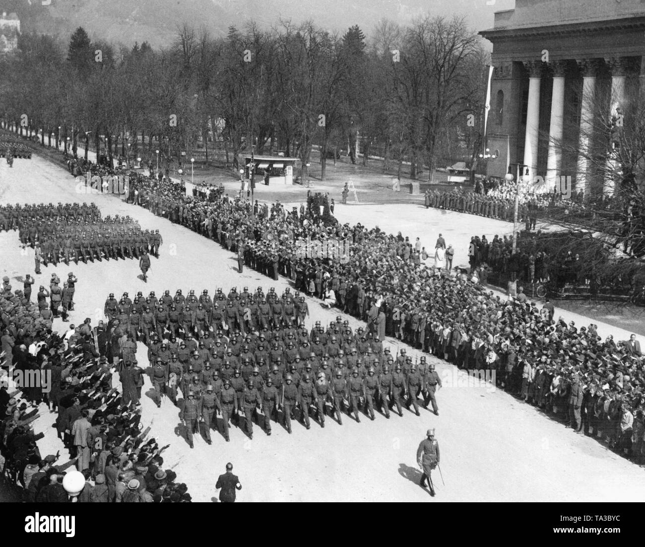 March of the Tiroler-Jaeger-Regiment and the German Gebirgsjaeger-Regiments 98 on the Adolf Hitler Platz in Innsbruck. After the annexation of Austria to the German Reich, the Austrian army is sworn in to Hitler. Stock Photo