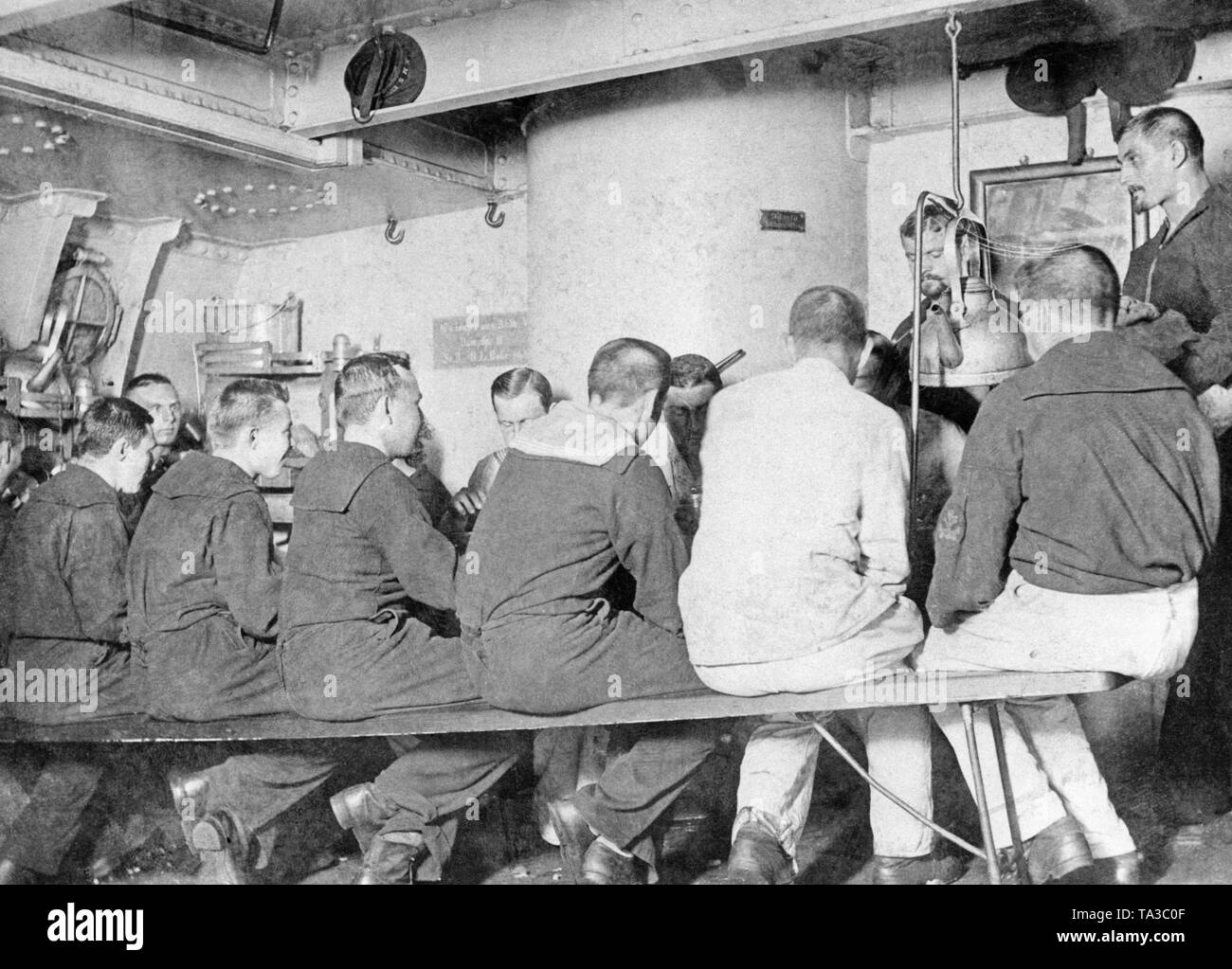 Sailors having dinner in the crew mess of a warship. Stock Photo
