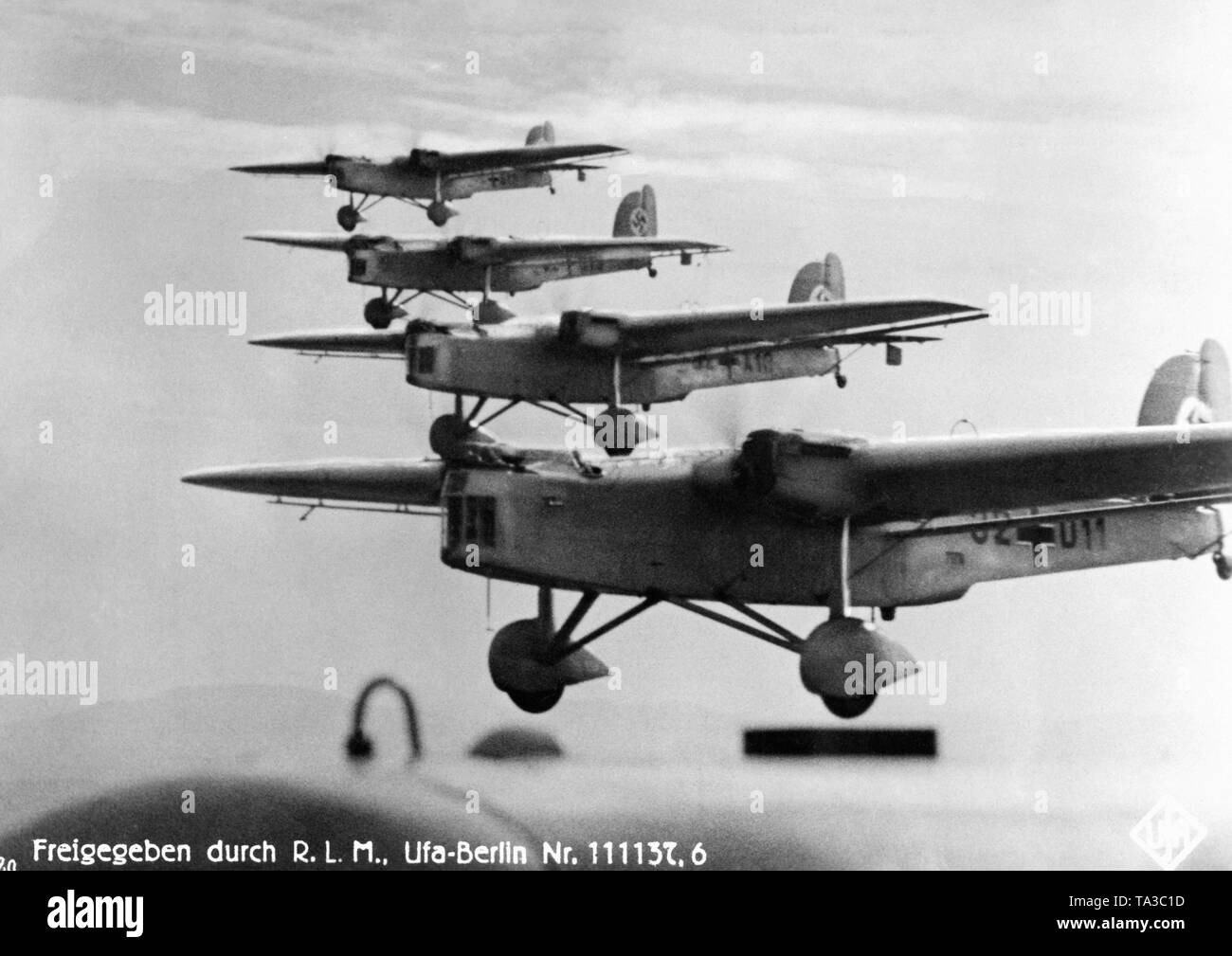 A bomber squadron of the Luftwaffe consisting of machines of the type (presumably) Dornier Do 23 during approach on the 'Zieldorf' during a maneuver. It is a picture from the Nazi propaganda film 'Flieger, Funker, Kanoniere' from 1937. Stock Photo