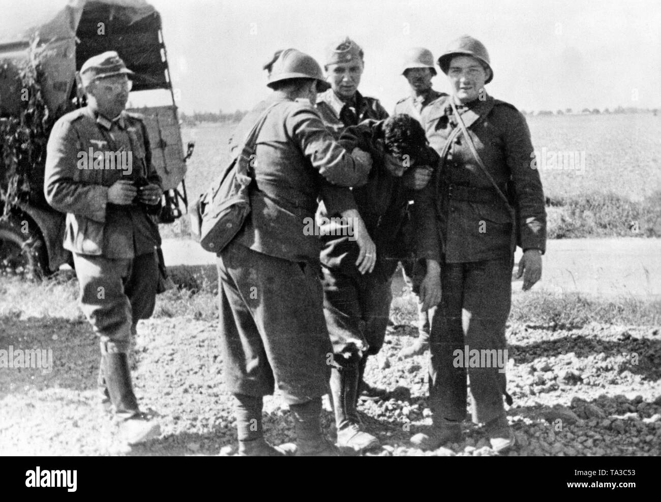 French soldiers bring a wounded comrade to the German troops. Photo: Gofferje Stock Photo