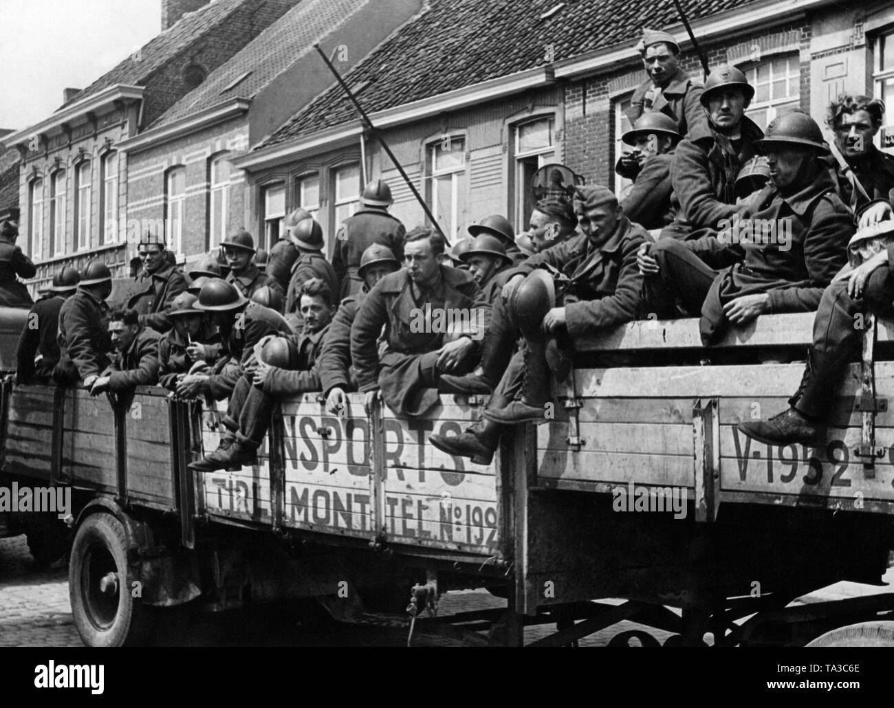 Soldiers are brought back on civilian trucks. Stock Photo
