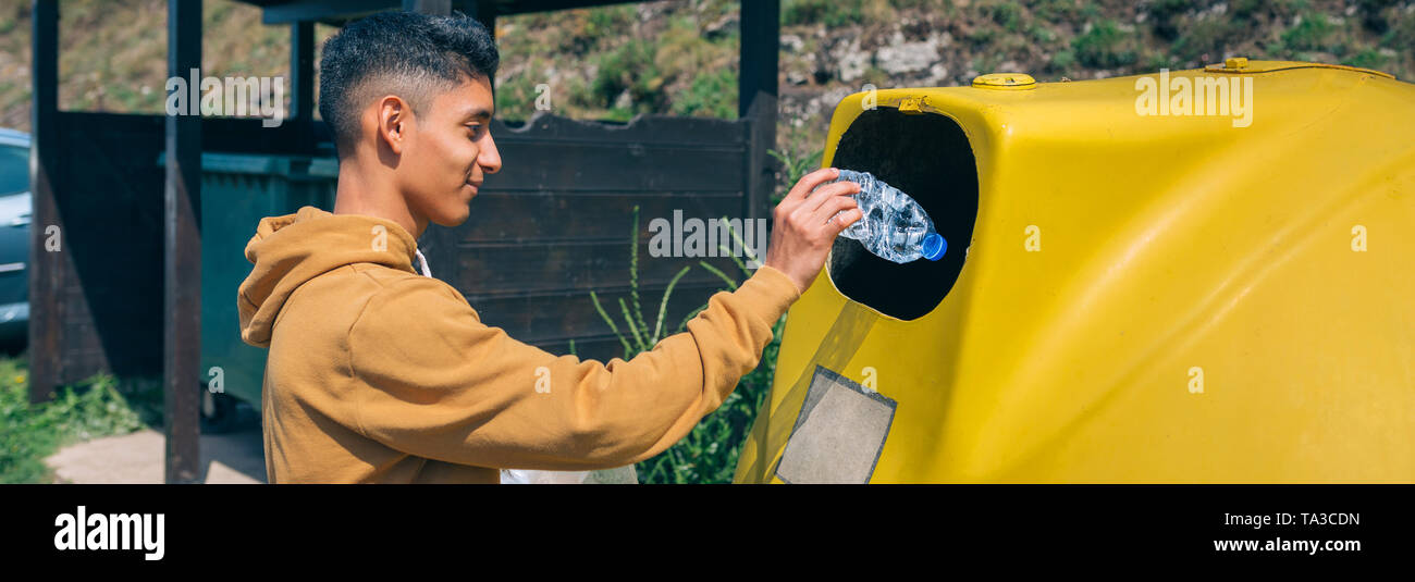 Man throwing garbage to container Stock Photo Alamy