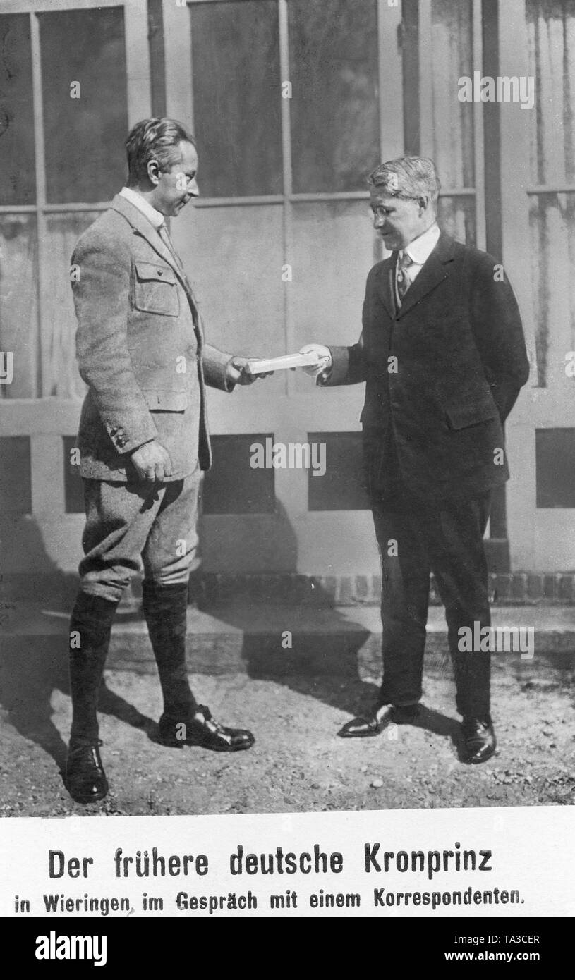 The German Crown Prince (left) in conversation with a newspaper correspondent, who hands him a book. Stock Photo