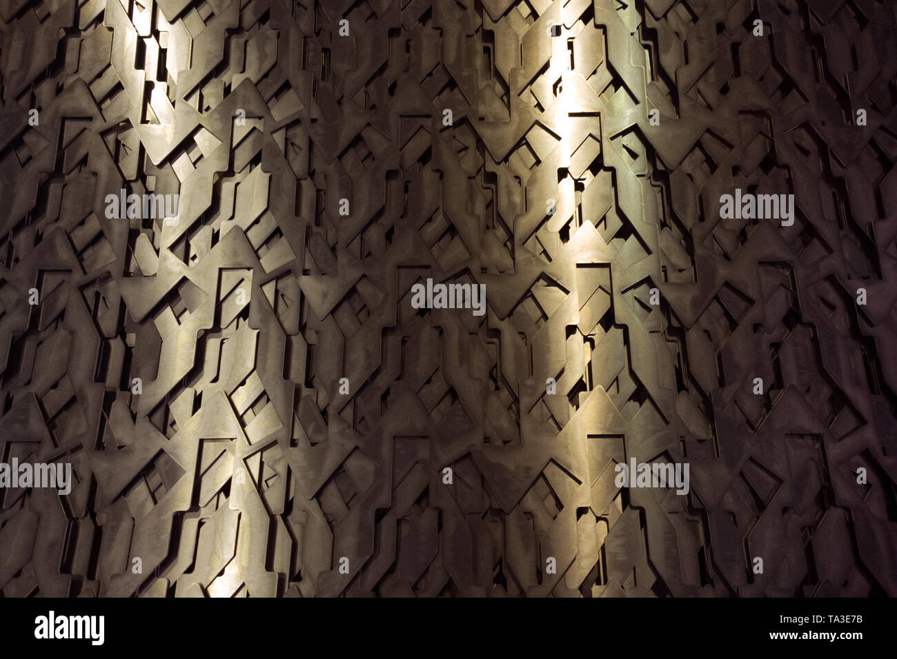 Light glow on grill pattern. Dark grainy industrial abstract background. Stock Photo