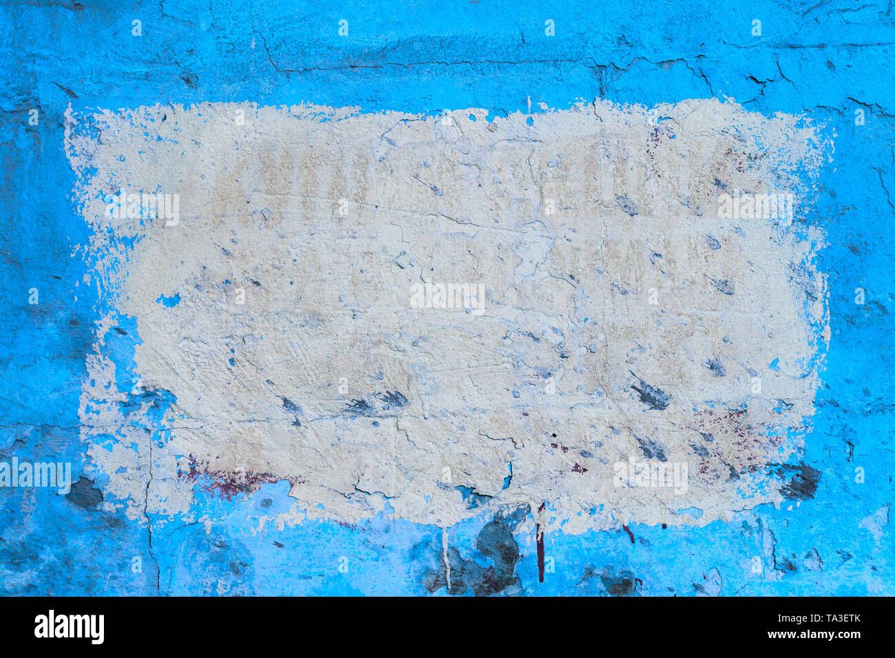 Blue plsater wall with black mold background and white rectangular on it. Stock Photo