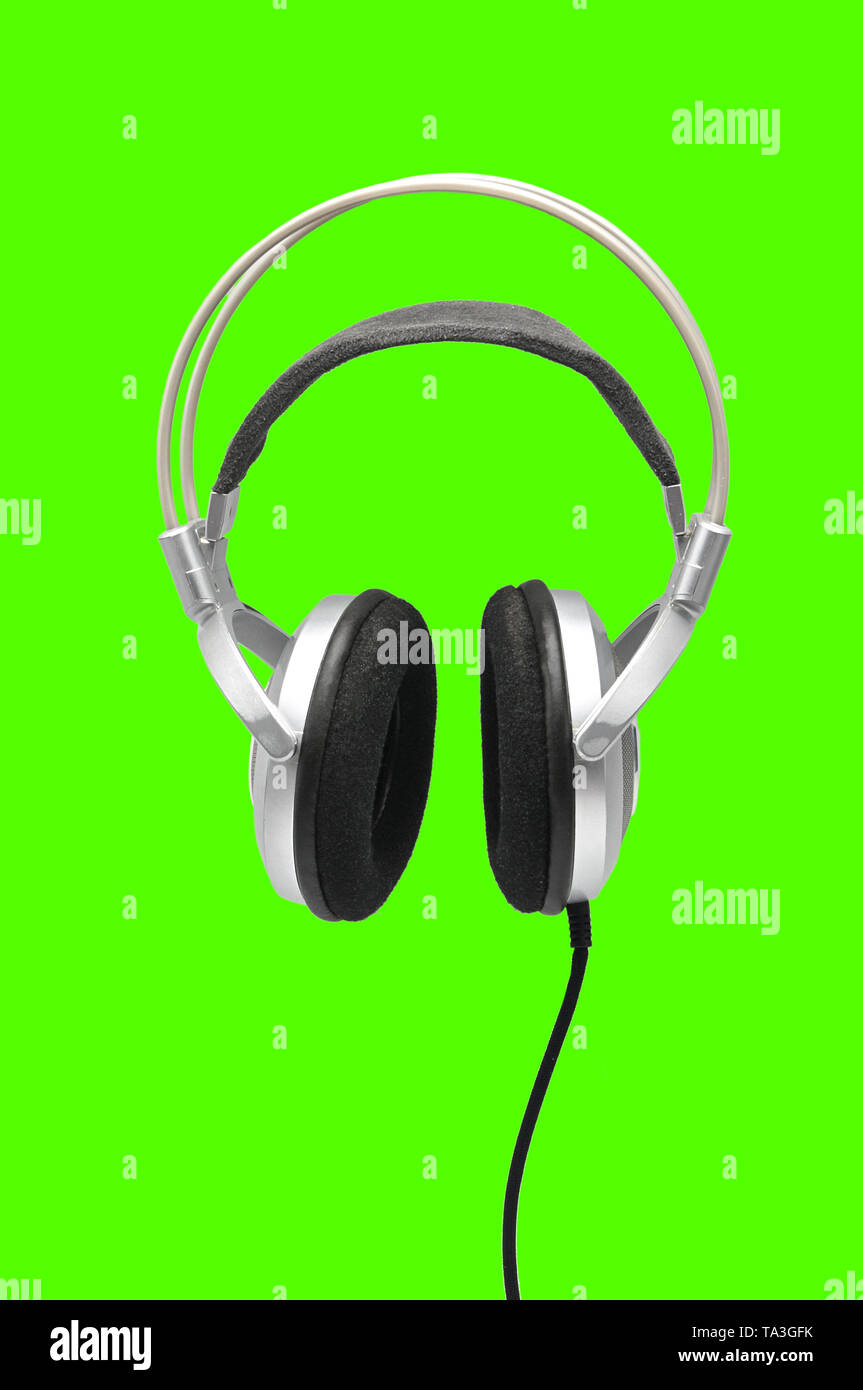 Vintage headphones for listening to sound and music on an isolated green  background Stock Photo - Alamy
