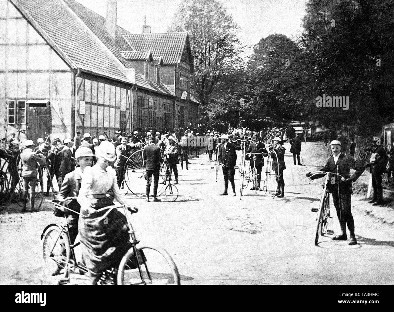 A group of cyclists in Friedrichsruh, the retirement seat of Otto von Bismarck. Possibly the visit of the members of a cycling club. From a contemporary publication. Stock Photo
