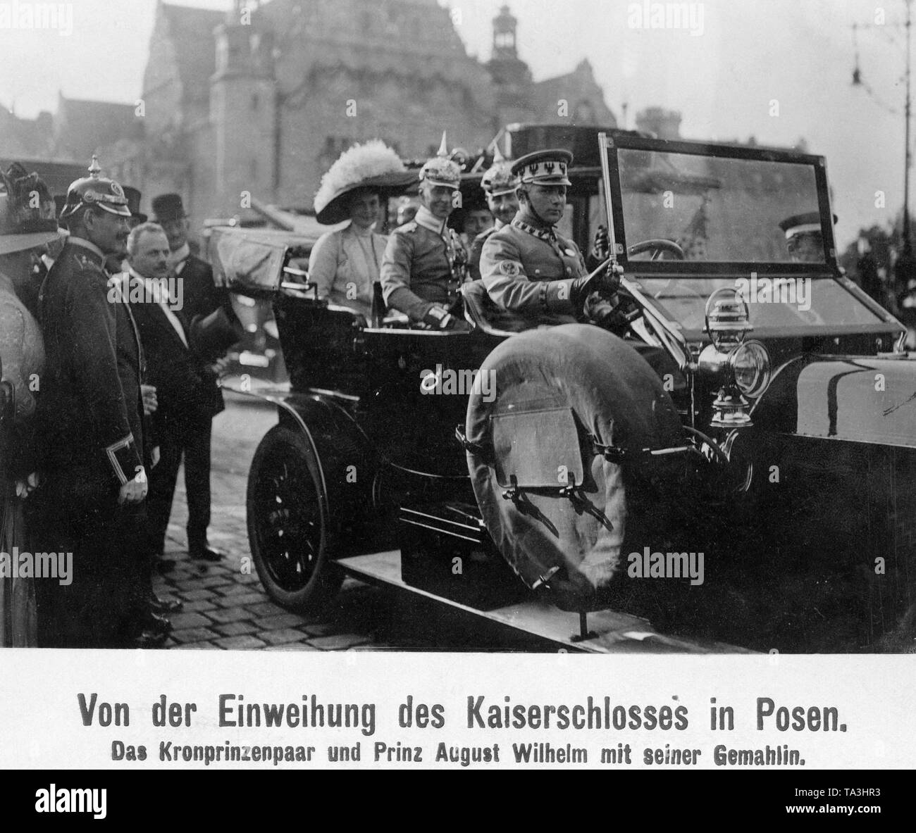 In the car Crown Prince Wilhelm of Prussia (behind the driver left) and Prince August Wilhelm of Prussia (right) drove to the inauguration of the castle built by William II. Behind them are their wives: Crown Princess Cecilie von Mecklenburg (left) and Princess Alexandra Viktoria of Schleswig-Holstein-Sonderburg-Gluecksburg (right). Stock Photo