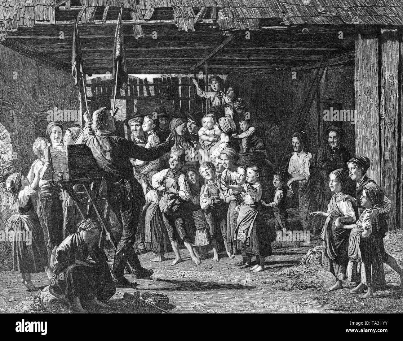 This photo shows one of the oldest forerunners of film history, the Guckkastenmaenner (the peep-show men), they were later replaced by the laterna magica. This photo, after a contemporary drawing by the painter Ferdinand Georg Waldmueller, shows the Guckkastenmann in a farm barn with his picture box mounted on a wooden carrying rack. The viewers are offered pictures in the box and matching stories. The peep show men were mainly in Vienna and appeared on large, busy places. Stock Photo