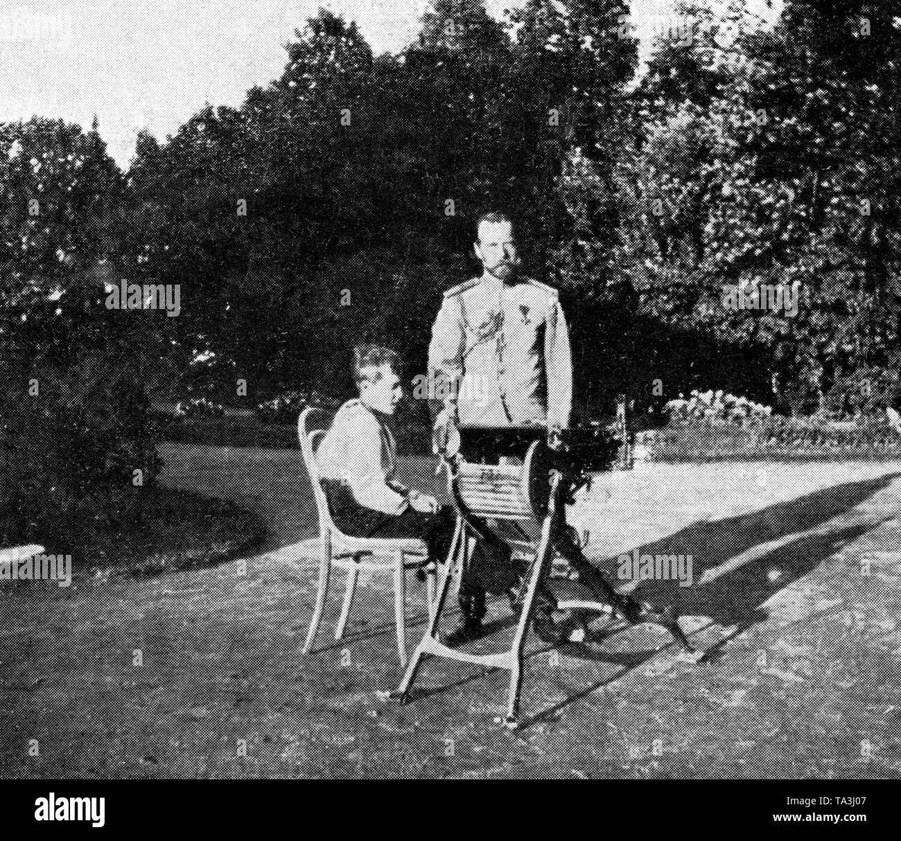 Tsar Nicholas II of Russia with his son and heir to the throne Alexei in the garden. Undated photo from around 1914. Stock Photo