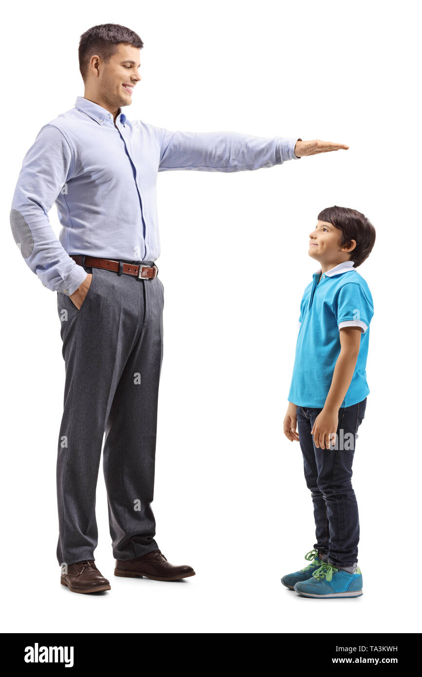 Full length shot of a father measuring how tall his son is isolated on white background Stock Photo