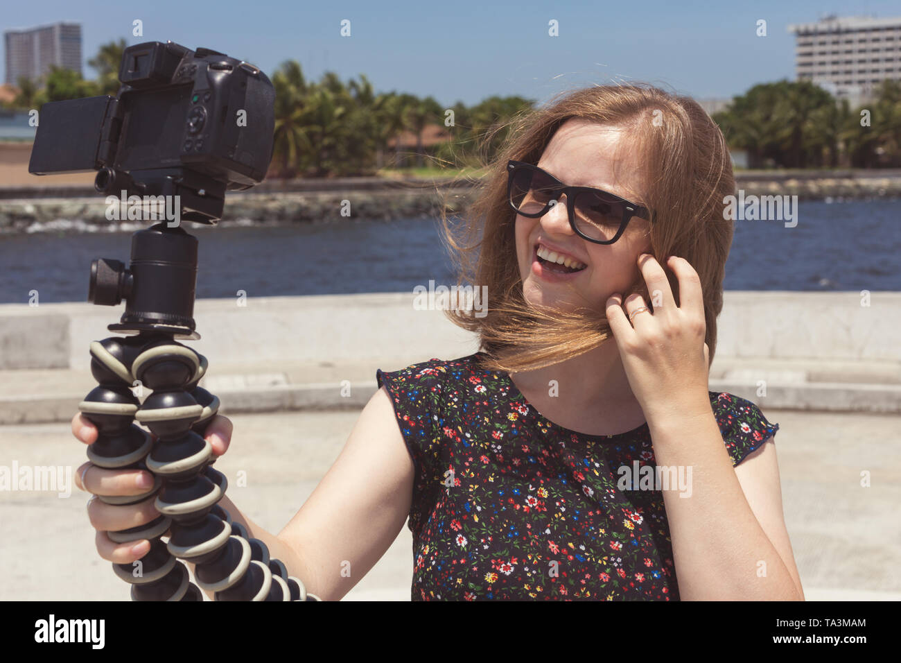 Camera recording a young caucasian female blogger gesturing while making a video Stock Photo