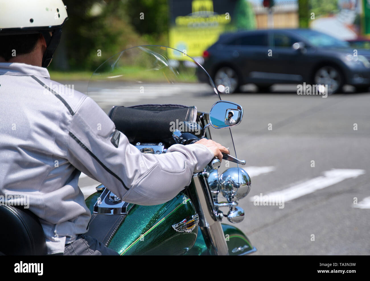 Durham, CT USA. May 2019. A focused motorcyclist on side mirror enjoying the New England weather and small town sights while at an intersection. Stock Photo