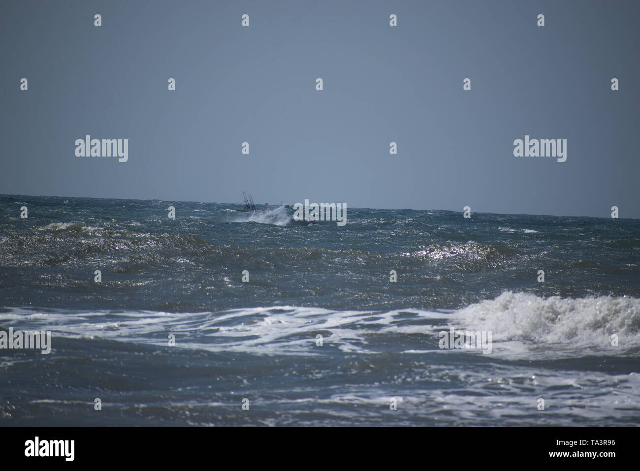Small boat in heavy seas Stock Photo Alamy
