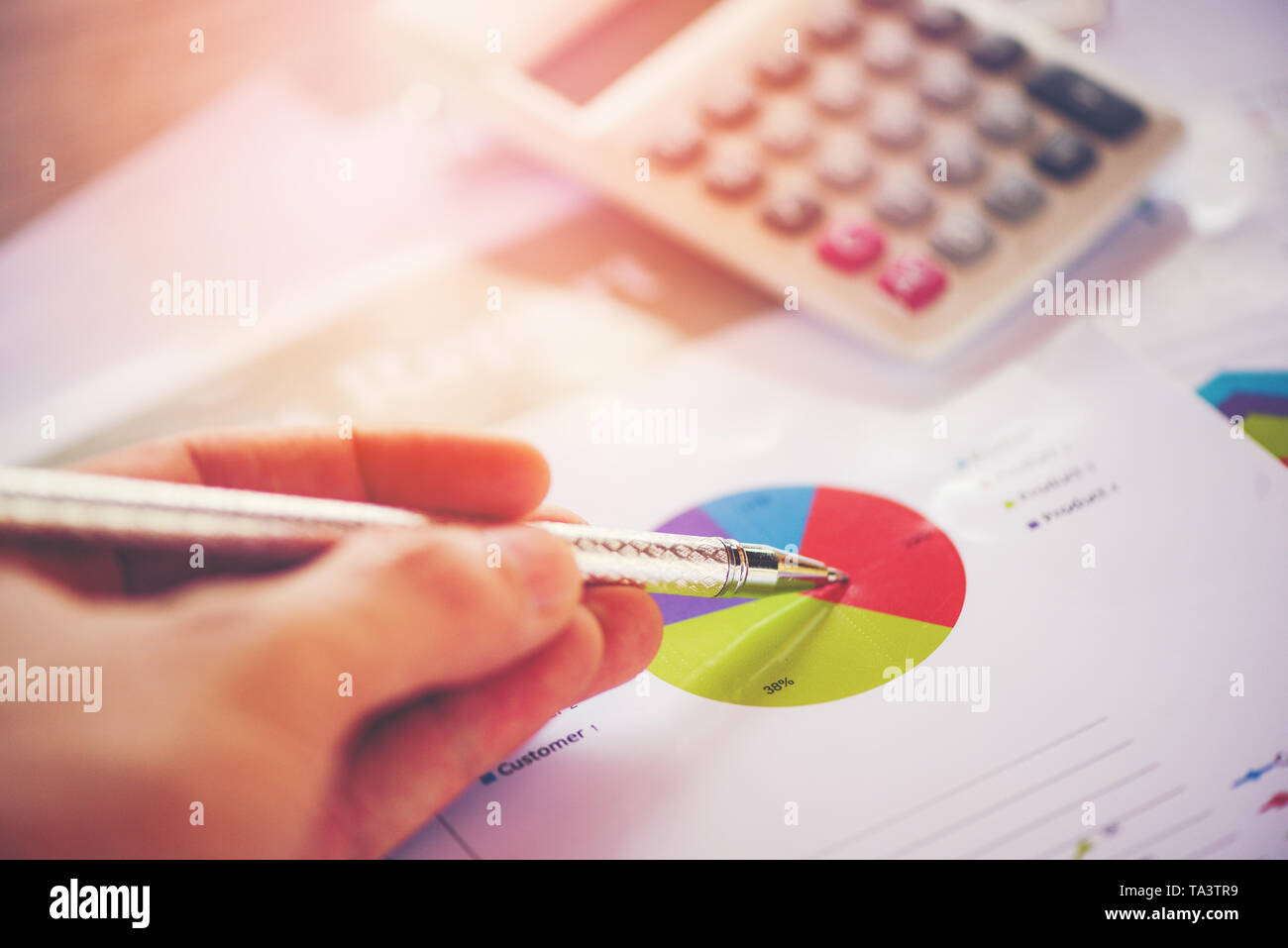Business report chart preparing graphs calculator concept / Summary report in Statistics circle Pie chart on paper business document financial with ha Stock Photo