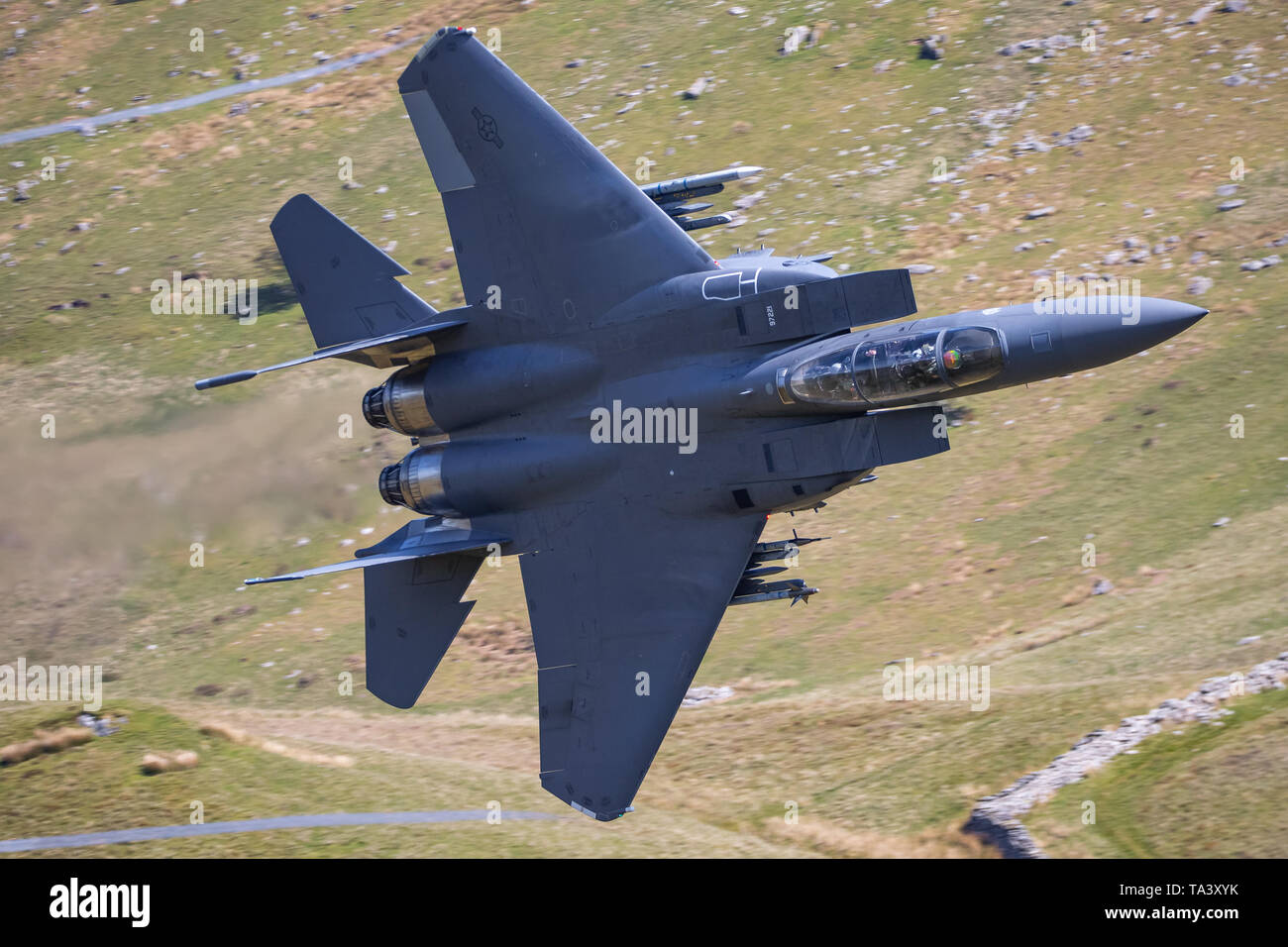 A USAF F-15 Strike Eagle passes through Mach Loop during low level training. Stock Photo