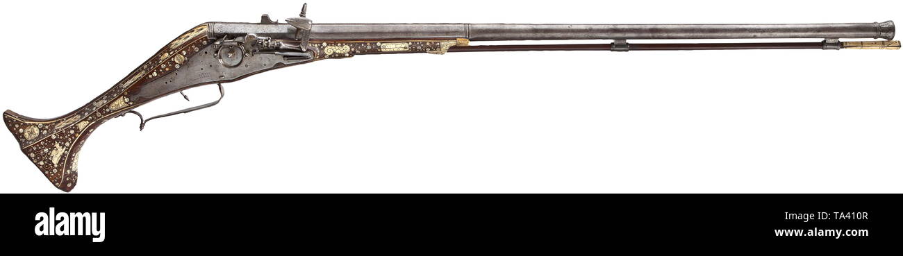 A North Italian bone-inlaid wheellock wall rifle, circa 1600 A heavy, octagonal to round barrel with cannon muzzle, smooth bore in 20.5 mm calibre. Both ends of the barrel with engraved acanthus ornaments. Applied sights. Large lock with exterior wheel. On the left side pierced holes for the originally also existent matchlock mechanism. The lock plate inscribed 'LOVISO CRENA'. Walnut half stock with rich inlays of engraved bone. Profuse decoration of mythical creatures, trophy bundles and fruit festoons between dot inlays and scrolling leaves. On, Additional-Rights-Clearance-Info-Not-Available Stock Photo