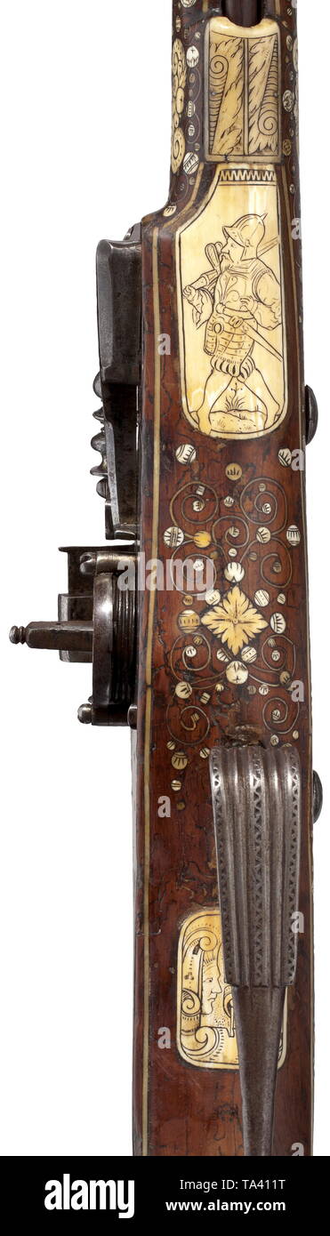 A North Italian bone-inlaid wheellock wall rifle, circa 1600 A heavy, octagonal to round barrel with cannon muzzle, smooth bore in 20.5 mm calibre. Both ends of the barrel with engraved acanthus ornaments. Applied sights. Large lock with exterior wheel. On the left side pierced holes for the originally also existent matchlock mechanism. The lock plate inscribed 'LOVISO CRENA'. Walnut half stock with rich inlays of engraved bone. Profuse decoration of mythical creatures, trophy bundles and fruit festoons between dot inlays and scrolling leaves. On, Additional-Rights-Clearance-Info-Not-Available Stock Photo