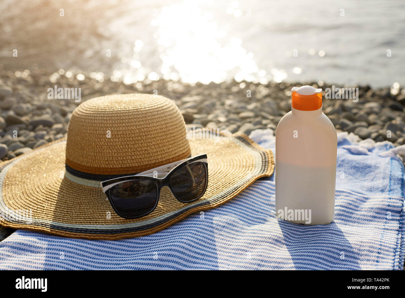 Tanned woman on beach and deck chair hires stock photography and