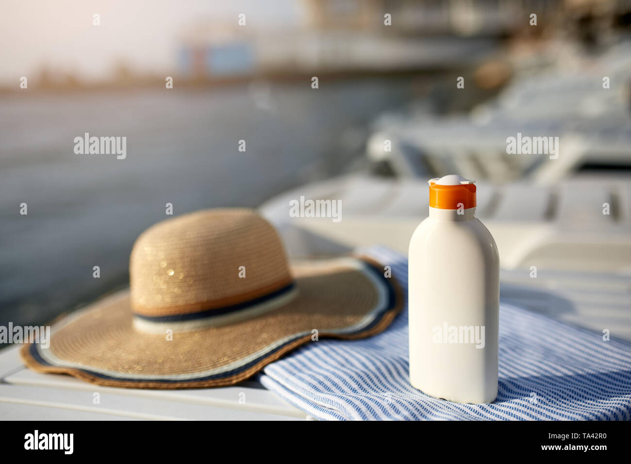 Tanned woman on beach and deck chair hires stock photography and