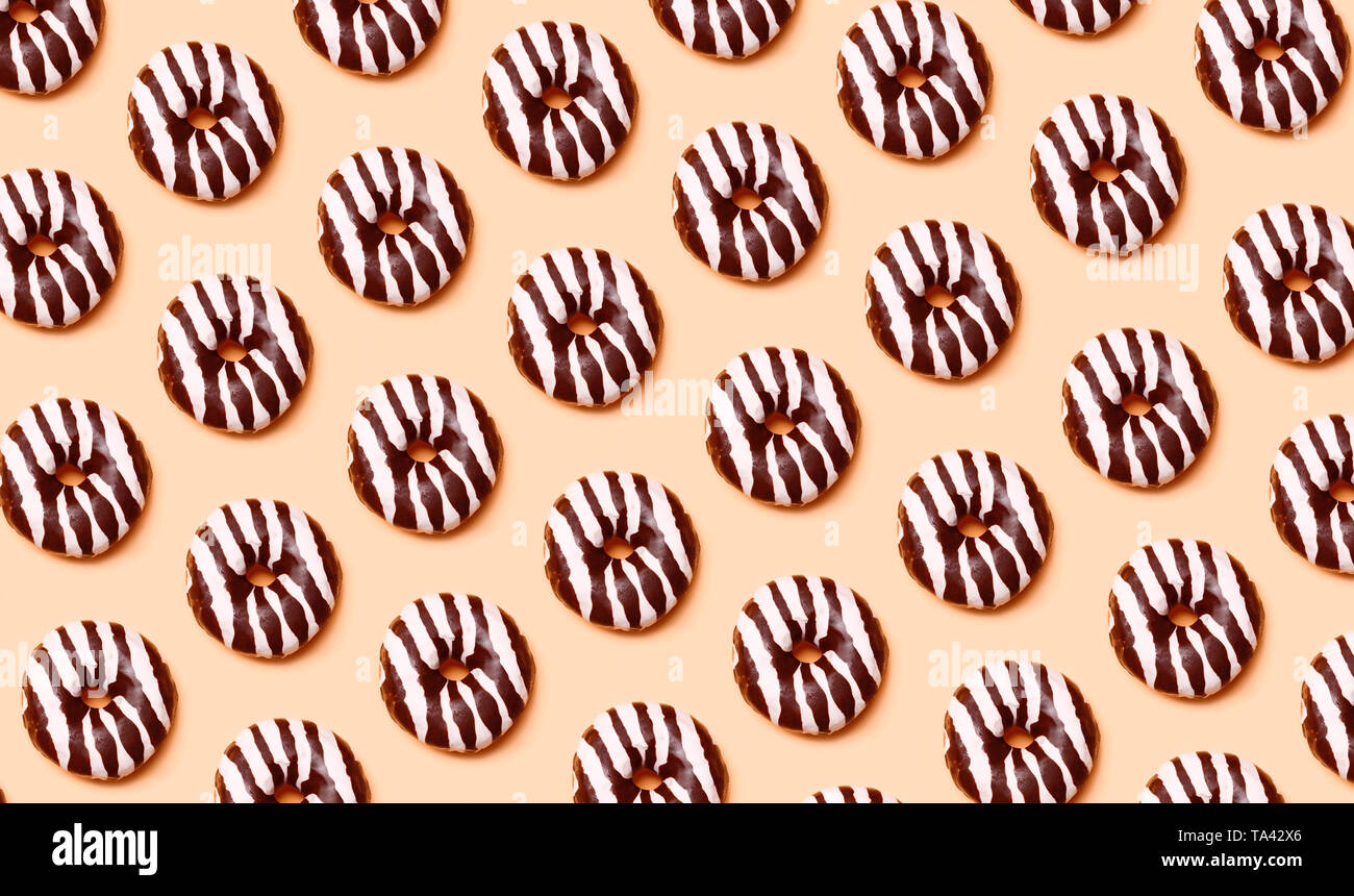 Chocolate donuts pattern on orange background Stock Photo