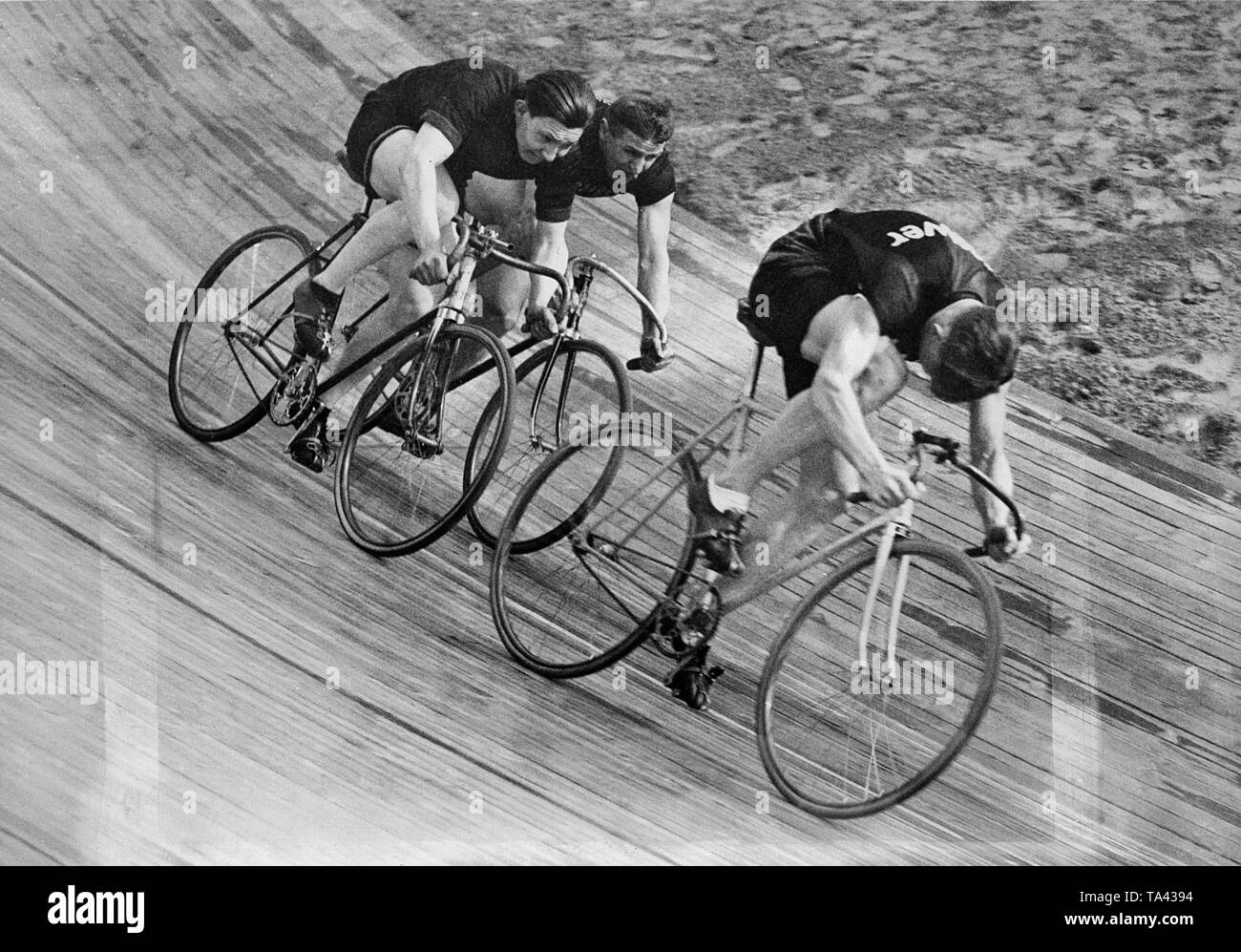 Three bike riders start the race at a velodrome Stock Photo Alamy
