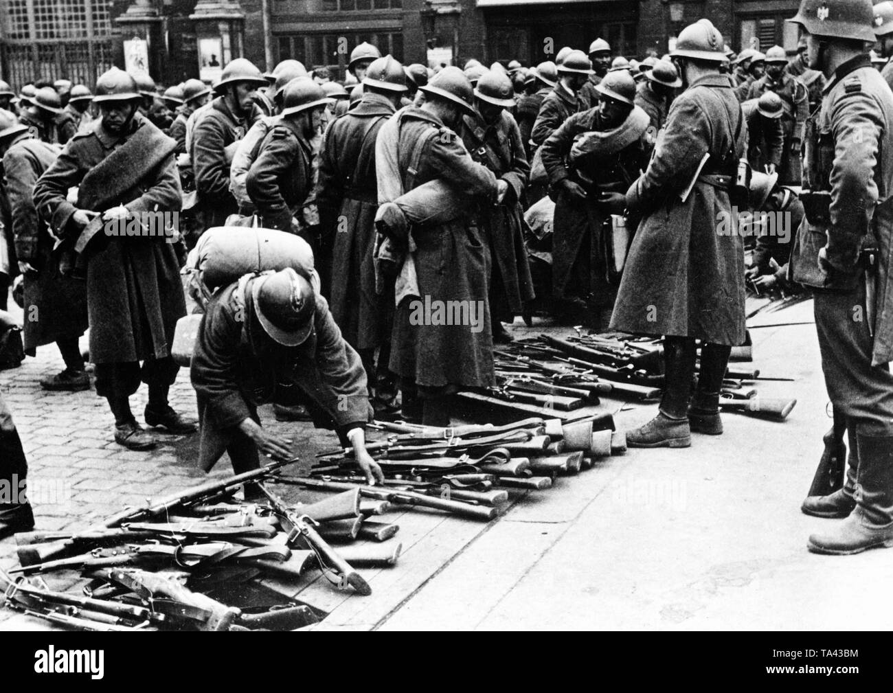 French soldiers lay down their arms. Photo: Fremke Stock Photo