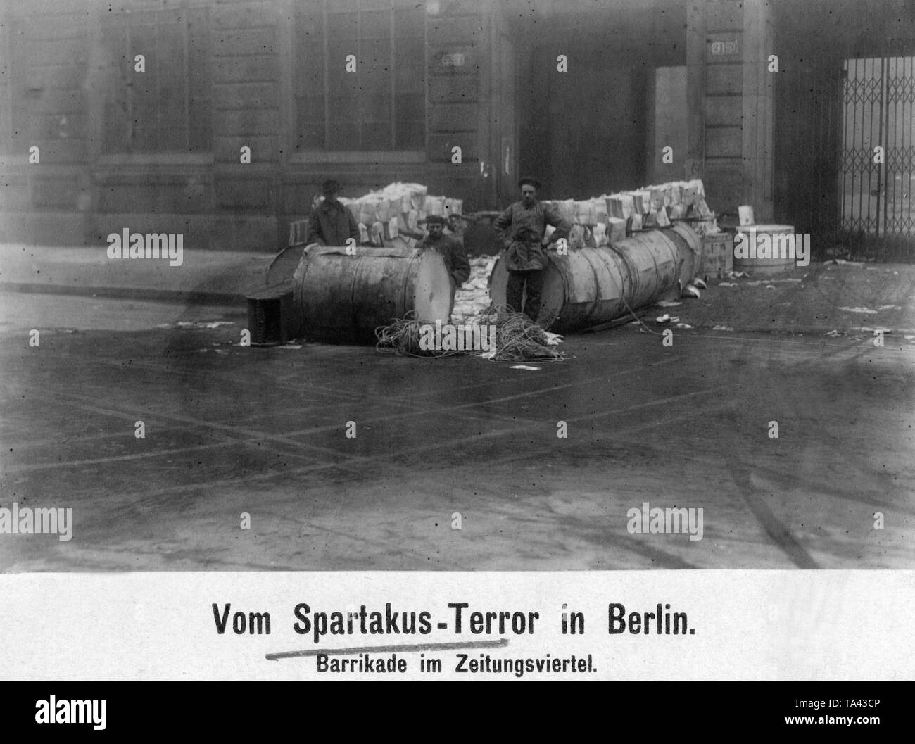 During the January uprising, there were armed conflicts between left-wing revolutionaries and government-loyal Freikorps units in the Berlin Zeitungsviertel (newspaper quarter). Here is a barricade reconquered by the government troops in front of the 'Mossehaus' in the Schuetzenstrasse. Stock Photo