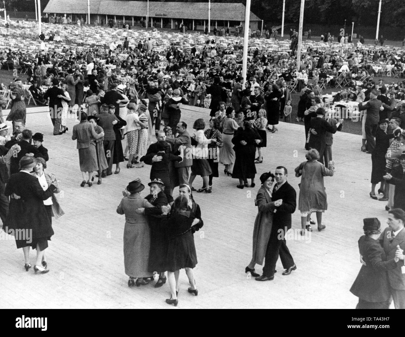 At a festival of the Nazi organization 'Kraft duch Freude' ('Strength through Joy') in Treptow, between performances the festival visitors are dancing on a dance floor of 700 square meters. Stock Photo