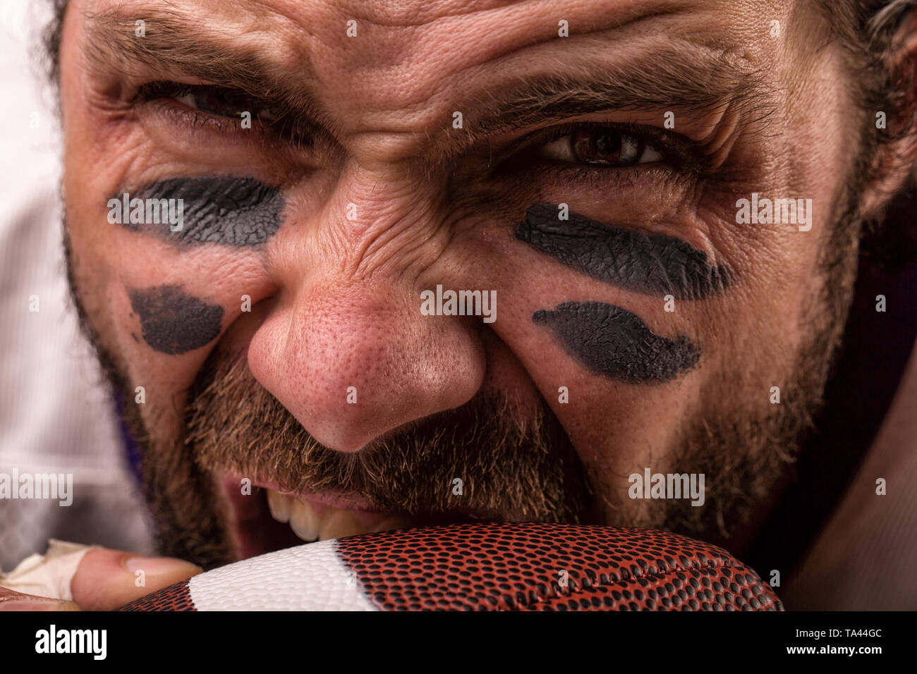 Close up portrait of aggressive American Football Player aggressive
