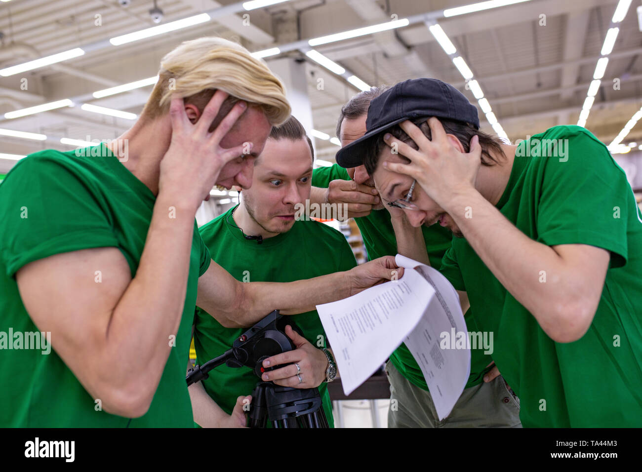 the team is shocked by the script, reading papers. backstage. Stock Photo