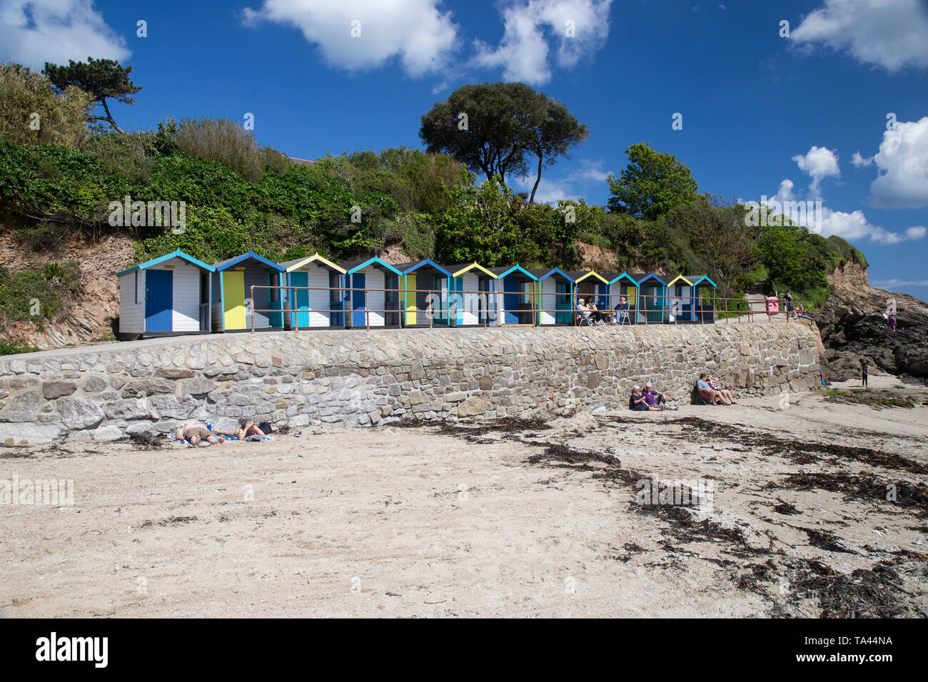 A Series Of Colourful Beach Huts Or Beach Cabins On The Harbour