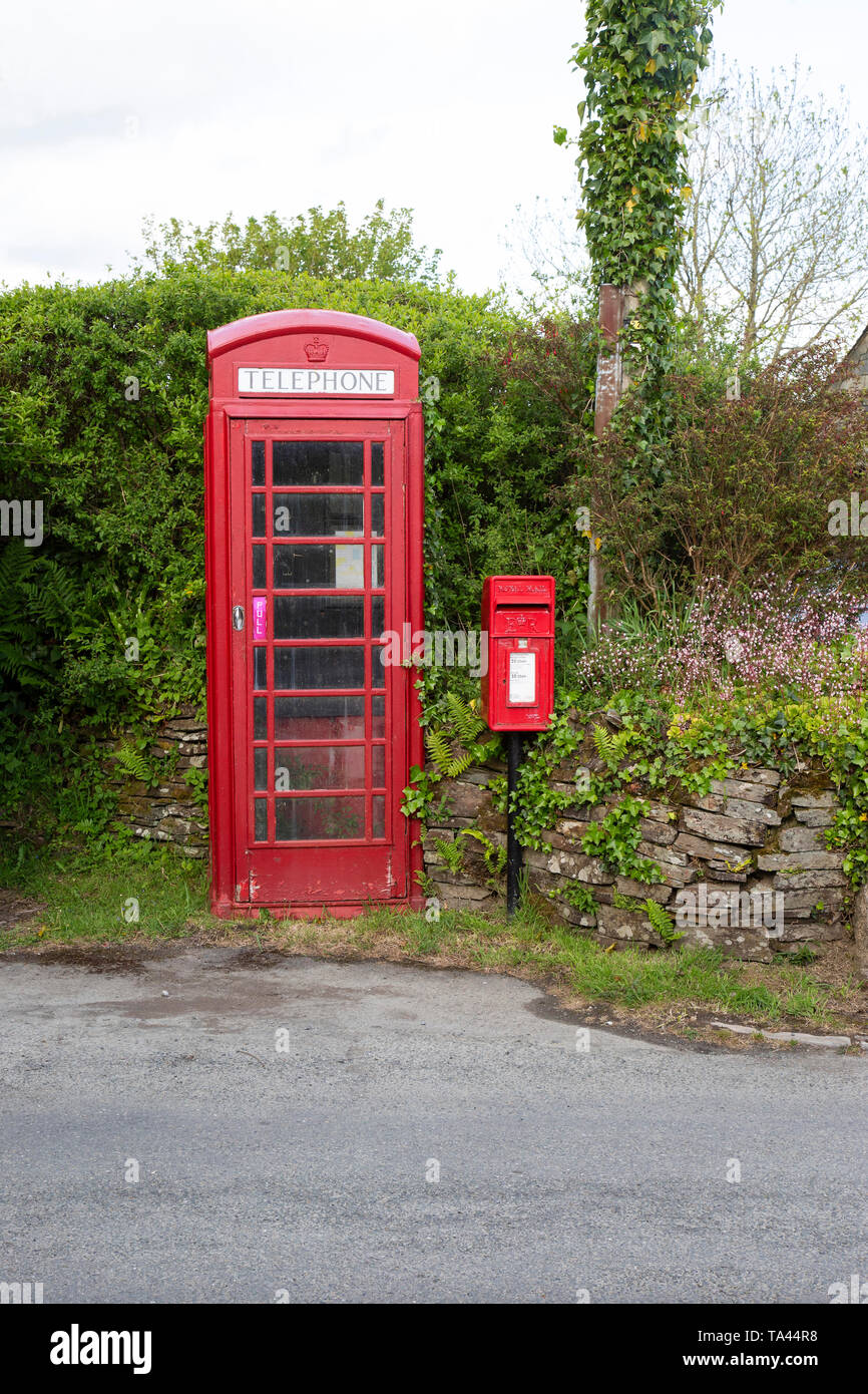 A traditional British red telephone box and Lamp box style postbox in a