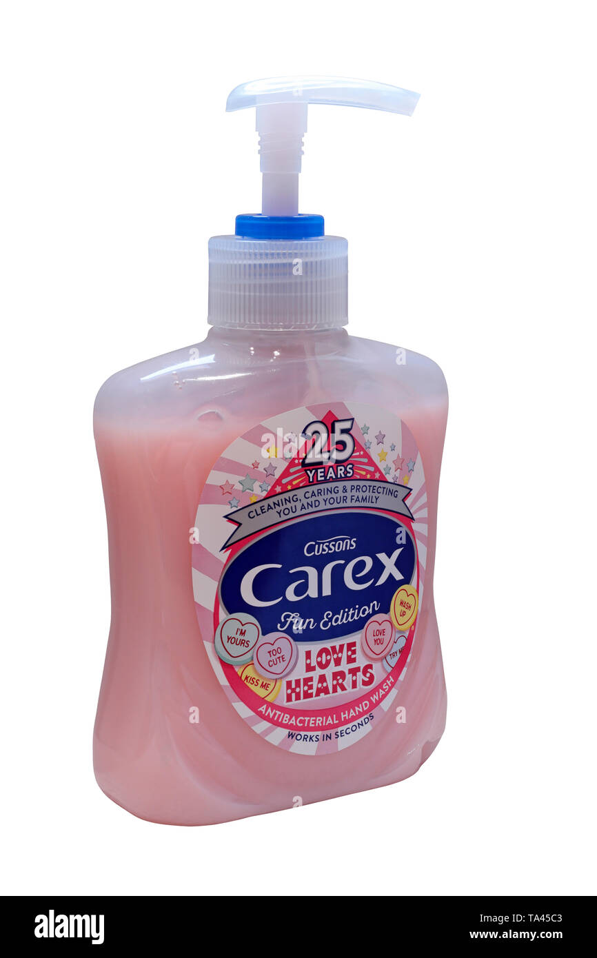 A pump action bottle of pink Cussons Carex Antibacterial Hand Wash - 25 years Fun Edition Love Hearts isolated on a white background Stock Photo