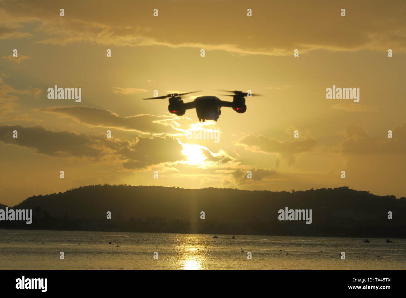 Drone flying at the beach, sunset Stock Photo