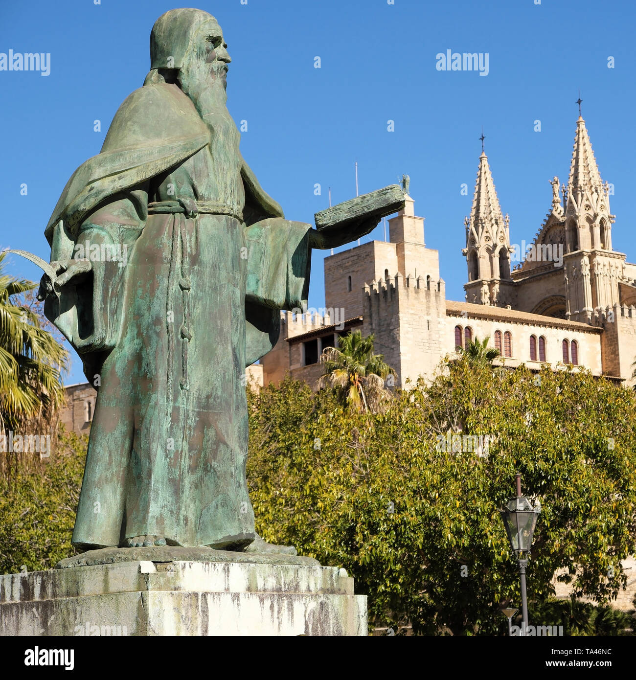 Palma de Mallorca, Spain - March 25, 2019 : side view of the famous gothic cathedral Santa Maria La Seu, the Kings palace Almudaina and statue of Ramo Stock Photo