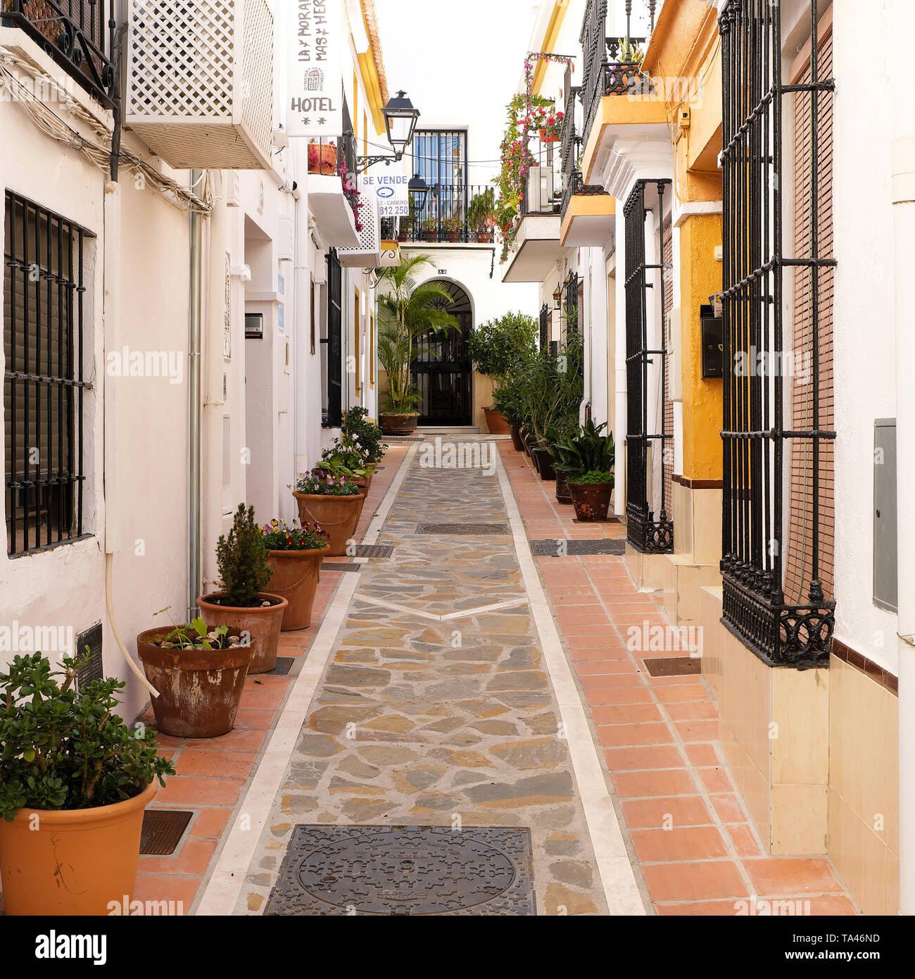 Marbella old town, Andalucia, Spain - March 13, 2019 : traditional whitewashed village houses and narrow street Stock Photo
