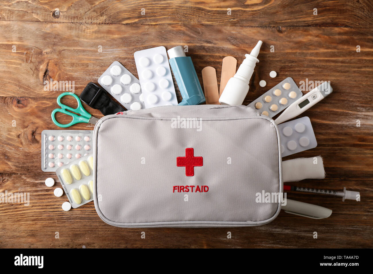First aid kit on wooden background Stock Photo - Alamy