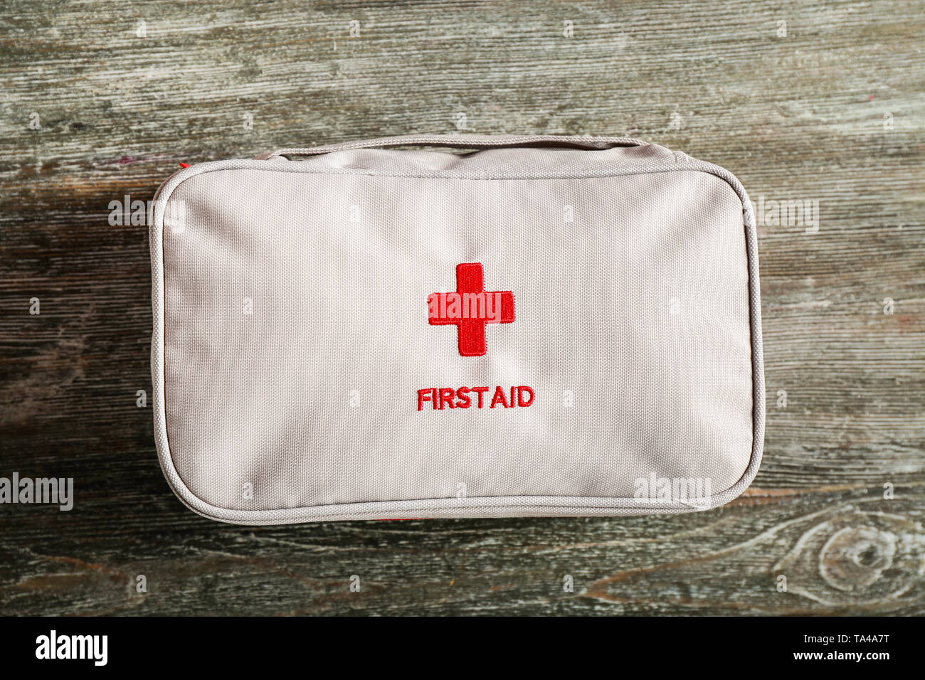 First aid kit on wooden background Stock Photo - Alamy