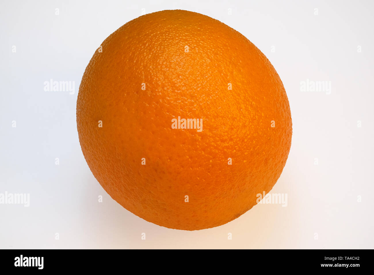 Whole ripe sweet orange close-up on a white background macro photo with a large depth of field Stock Photo