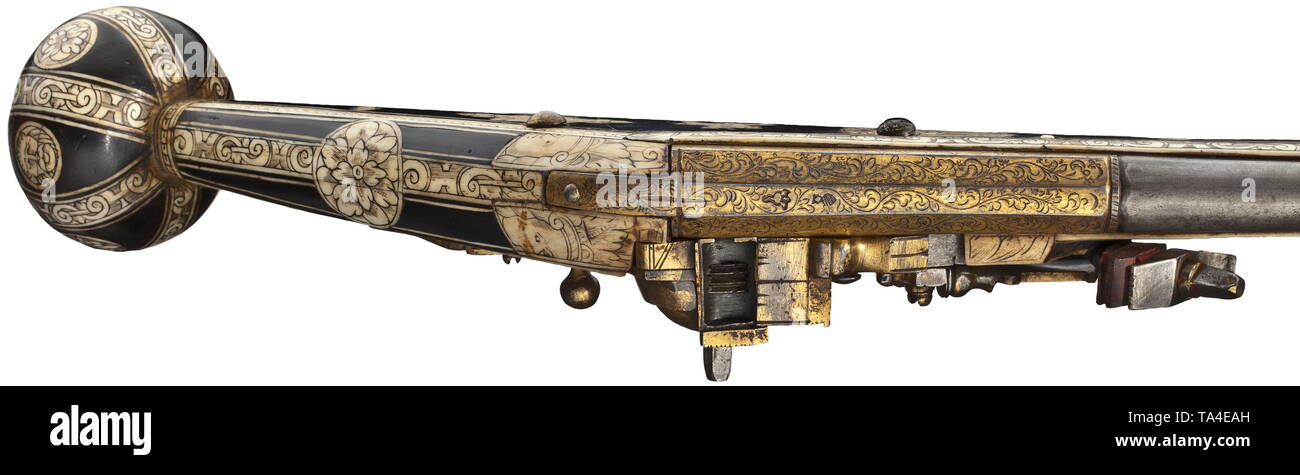 A bone-inlaid, gilt wheellock puffer, Augsburg, circa 1580/90 Two-stage barrel, octagonal breech section, then round after cut girdles, with smooth bore in 13 mm calibre. Over the muzzle and chamber florally engraved, gilt decoration. The top of the barrel with two struck Augsburg marks, Pyr and flower within a shield. Gilt and chiselled wheellock en suite engraved with flowers, with domed wheel cover and spring-loaded safety lever. Ebonised fruitwood stock with engraved and blackened, profuse bone inlays. The pommel with stripe and disc inlays i, Additional-Rights-Clearance-Info-Not-Available Stock Photo