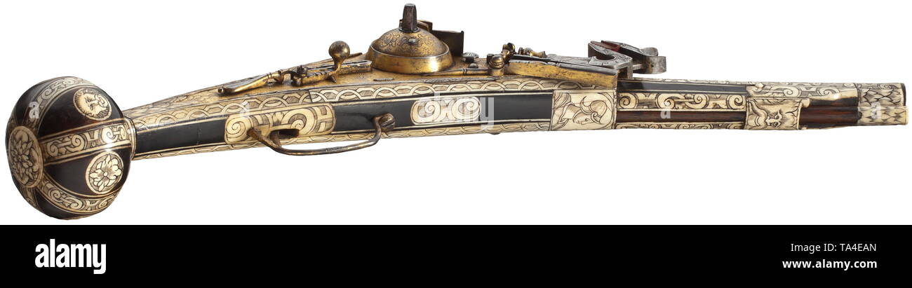 A bone-inlaid, gilt wheellock puffer, Augsburg, circa 1580/90 Two-stage barrel, octagonal breech section, then round after cut girdles, with smooth bore in 13 mm calibre. Over the muzzle and chamber florally engraved, gilt decoration. The top of the barrel with two struck Augsburg marks, Pyr and flower within a shield. Gilt and chiselled wheellock en suite engraved with flowers, with domed wheel cover and spring-loaded safety lever. Ebonised fruitwood stock with engraved and blackened, profuse bone inlays. The pommel with stripe and disc inlays i, Additional-Rights-Clearance-Info-Not-Available Stock Photo