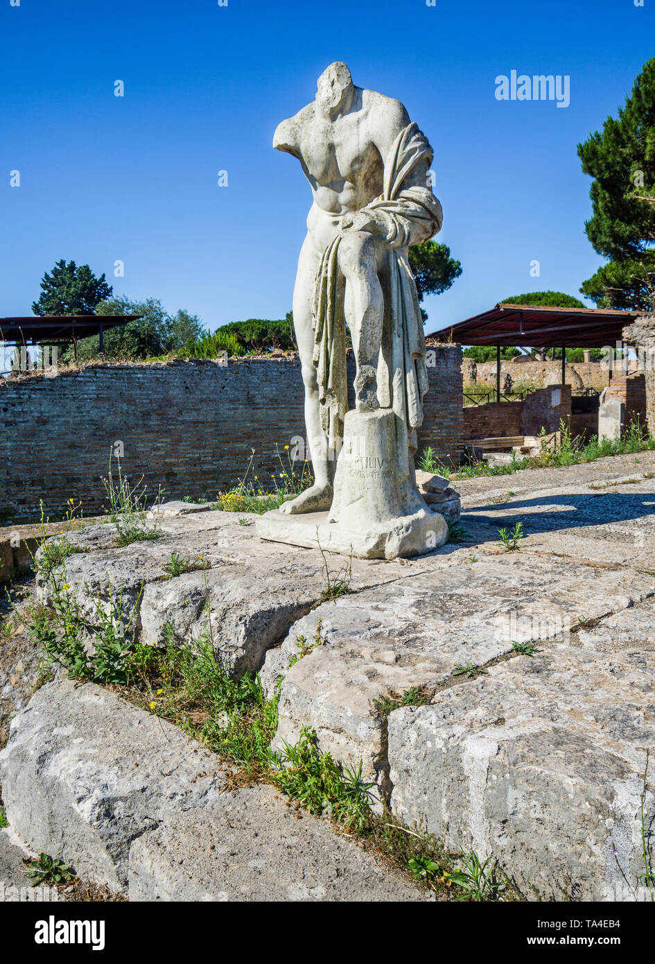 marble statue dedicated to Hercules at Tempio di Ercole, the Temple of Hercules, archeological site of the Roman settlement of Ostia Antica, the ancie Stock Photo