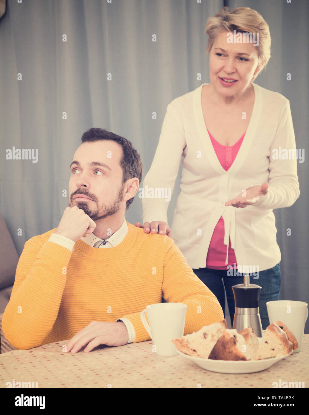 Mature mother tries to reconcile with his son and find out relationship Stock Photo