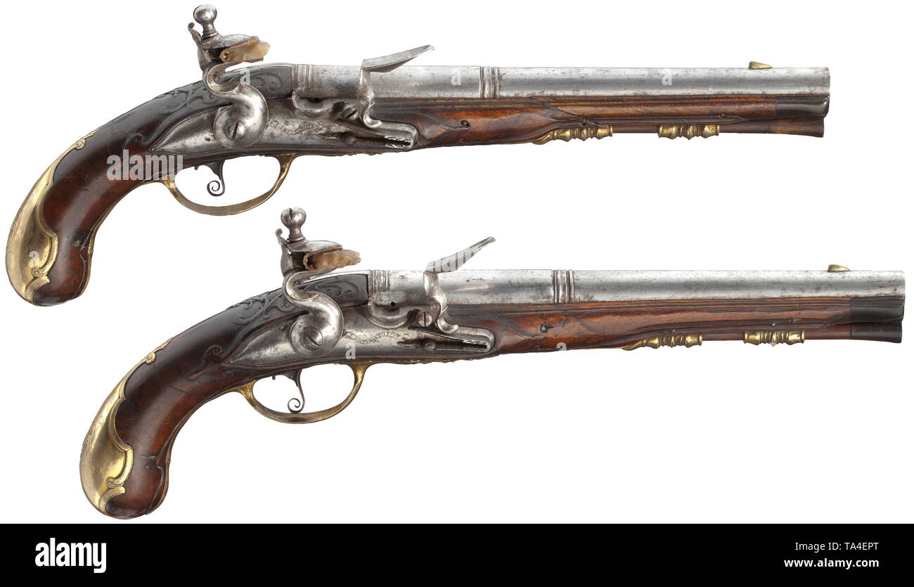 A pair of flintlock pistols, P. Knust, Mürau (Mirov), Moravia/CZ, circa 1730 Round and smooth two-stage barrels in 13.5 mm calibre with brass front sights. Lightly cut flintlocks, on both lockplates engraved signatures 'P. KNUST A MIROW'. Carved walnut stocks with horn nosepieces (both butts broken and adhered, one forearm with crack). Gilded, finely engraved brass furnitures, on both side plates engraved monogram 'J.C.V.Z.' Original wooden ramrods with horn tips. Length 36.5 cm each. P. Knust, Mürau, circa 1710-20. High-quality workmanship. Pist, Additional-Rights-Clearance-Info-Not-Available Stock Photo