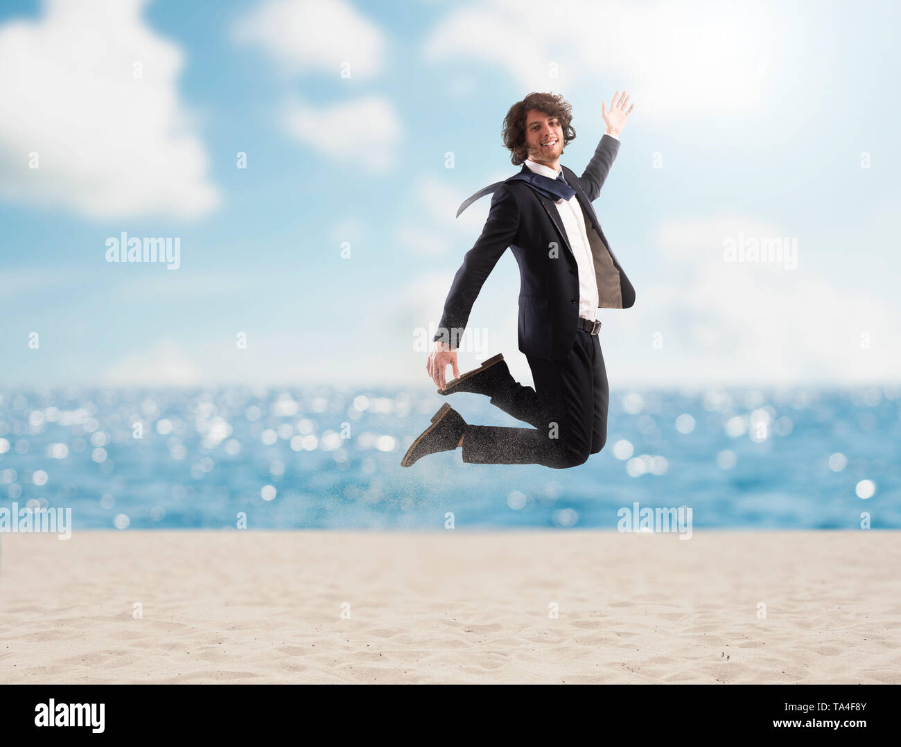 Businessman jumps on the sand. Concept of vacation Stock Photo