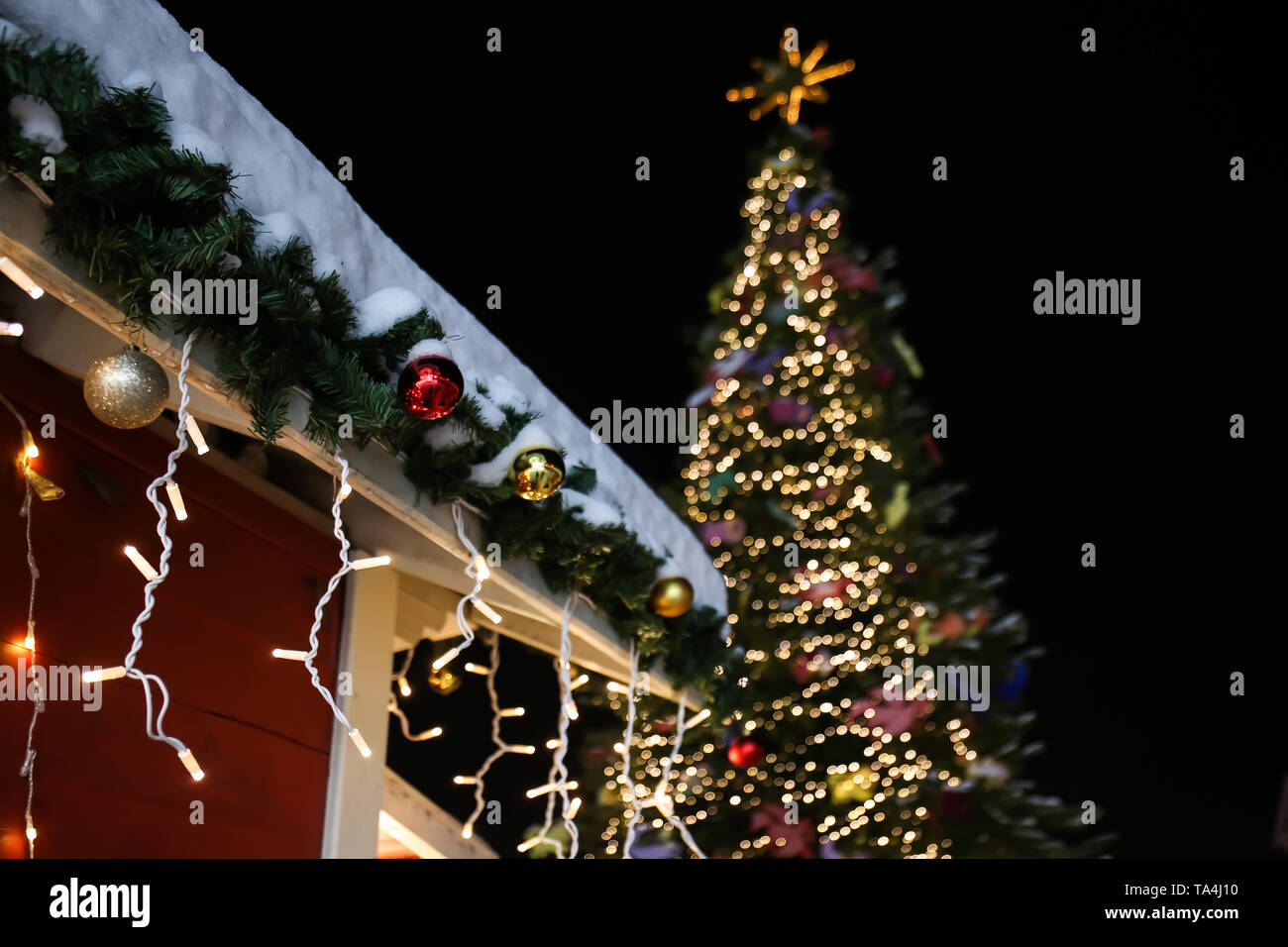 Beautiful Christmas Decorations Hanging On Roof Outdoors Stock