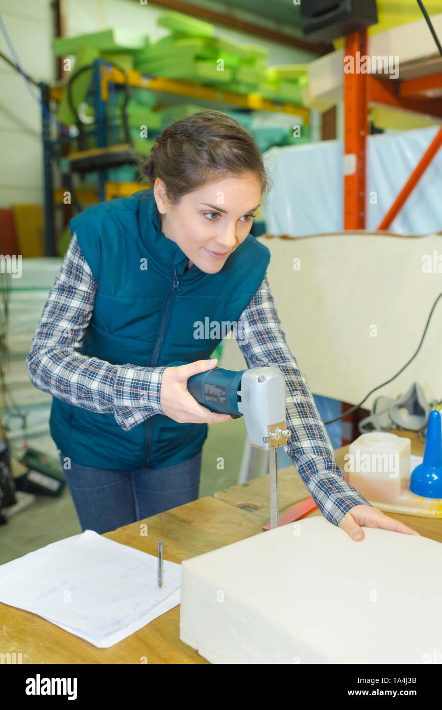 female worker fixing a chair Stock Photo - Alamy
