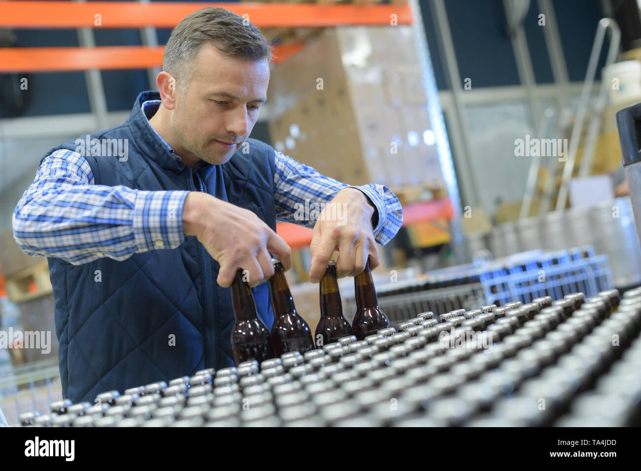 brewery worker lifting bottles Stock Photo Alamy